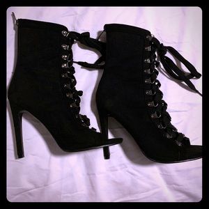 Black opened-toe, heeled boots